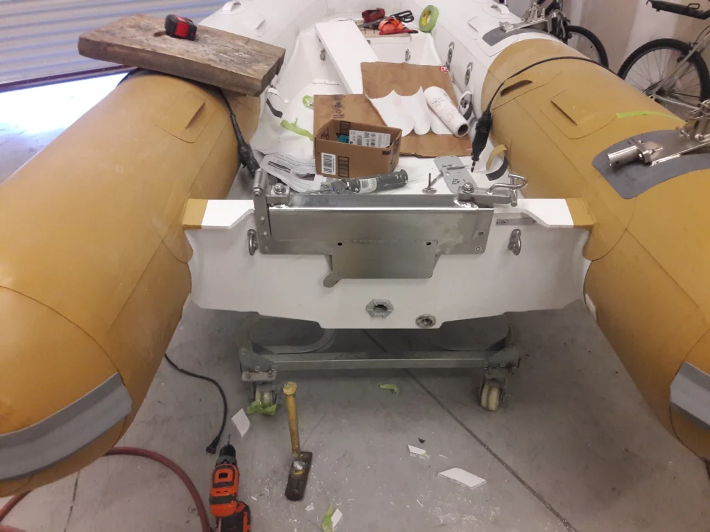 Custom transom and console base being fitted in a beige inflatable tender